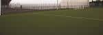 Vista lateral de la cancha deportiva interior con porterías visibles