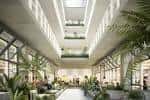 Espacio interior moderno convertido en zona de ocio o oficinas con plantas y luz natural
