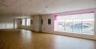 Salón amplio con suelo de parquet y ventanas laterales