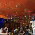 Interior del bar con iluminación cálida y ambiente festivo