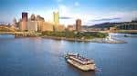 Vista panorámica del río con el skyline de Pittsburgh y un barco Gateway Clipper navegando