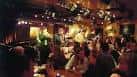 Interior del club con público asistiendo a un evento musical en ambiente acogedor