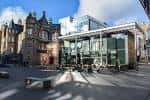 Fachada moderna del Söderberg Pavilion contrastando con edificios históricos de Edinburgh