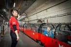 Personal del museo junto al tren rojo en la plataforma