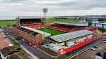 Vista aérea del estadio Pittodrie con gradas rojas y campo de fútbol