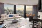 Área de lounge con sofás curvos y ventanales amplios hacia el skyline urbano