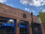 Fachada exterior de Union Cafe con detalles en ladrillo y toldos azules