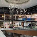 Atrio interior del centro comercial con iluminación moderna y escaleras