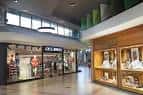 Pasillo interior del centro comercial mostrando tiendas y galerías
