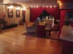 Sala de estar o zona de café del teatro con suelo de madera y cortinas rojas
