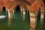 Interior del Depósito de Pronillo mostrando las bóvedas de ladrillo y las columnas sumergidas en agua