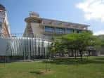 Vista exterior del edificio moderno de la Biblioteca Pública Yamaguchi rodeado de zonas verdes