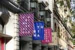 Detalle de las banderolas de colores con el nombre del espacio en la fachada
