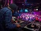 DJ pinchando música en directo frente a la pista de baile de la Sala Custom