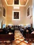 Interior del salón de actos con techos de gran altura y galería de retratos clásicos
