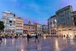 Vista de la Plaza de la Constitución durante el anochecer con las luces de la ciudad encendidas