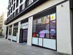 Fachada moderna de la oficina de turismo con amplios ventanales y señalización informativa