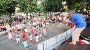 Celebración de un evento comunitario con actividades infantiles y público en el barrio