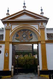Fachada de la puerta principal de acceso con escudo heráldico en azulejos