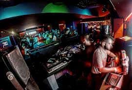 Detalle de la cabina de DJ y el público durante una sesión en Lanna Club