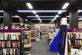 Interior amplio de la librería con estanterías y zonas de exposición
