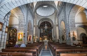 Perspectiva interior que muestra la estructura de arcos de piedra y la cúpula del templo