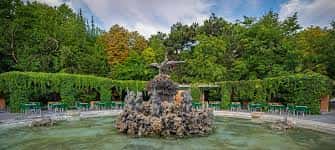 Estanque de la Fuente del Cisne con una zona de terraza y pérgola al fondo
