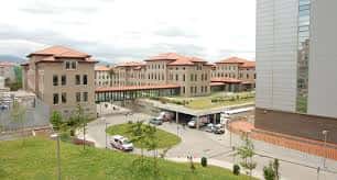 Fachada principal del complejo hospitalario con edificios de ladrillo y zonas verdes
