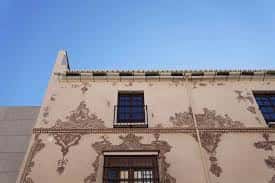 Detalle arquitectónico de la fachada superior del palacio con motivos decorativos