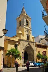 Vista exterior de la fachada principal de la Iglesia de San Isidoro en Sevilla con su torre campanario