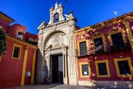 Fachada principal de la Basílica del Gran Poder con cielo azul y árboles