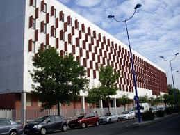 Fachada lateral de la Facultad de Comunicación con patrón geométrico en tonos rojos y blancos