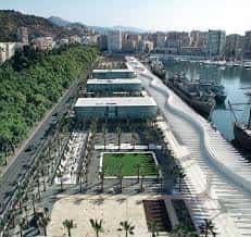 Vista aérea del Palmeral de las Sorpresas con palmeras y edificios modernos junto al puerto