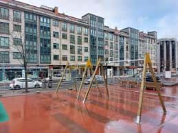 Vista general de la Pasarela de Xosé Adrio Barreiro con el parque infantil y edificios modernos al fondo
