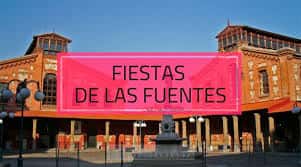 Fachada principal del recinto con gran pancarta rosa que anuncia las Fiestas de Las Fuentes