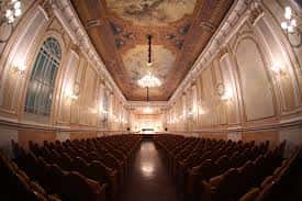 Sala de conciertos con techo pintado y arcos ornamentales