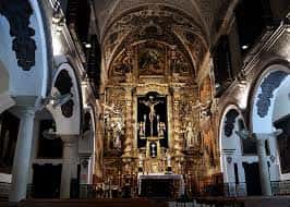 Interior amplio de la capilla con vista al altar mayor y columnas laterales