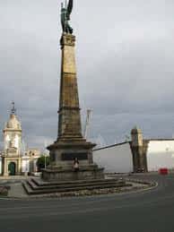 Detalle del monumento principal en la Plaza de Galicia bajo cielo nublado