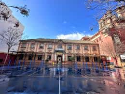 Vista exterior del CEIP San Jacinto con patio deportivo y fachada histórica