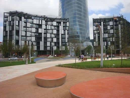 Vista diurna de la Plaza Euskadi con edificios modernos y el Torre Iberdrola al fondo