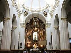 Interior de la Iglesia del Carmen con altar principal y columnas blancas