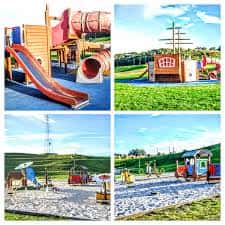 Zona de juegos infantiles con estructuras coloridas y áreas de arena
