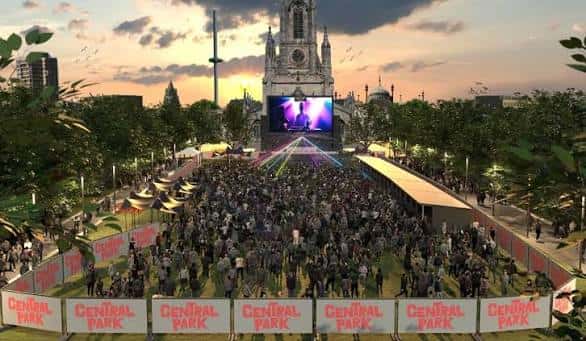 Vista panorámica del evento al atardecer con escenario y multitud