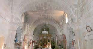 Interior de la iglesia con bóveda de cañón, altar mayor y lámpara central