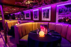 Zona de banquetes con sofás acolchados y decoración temática en paredes