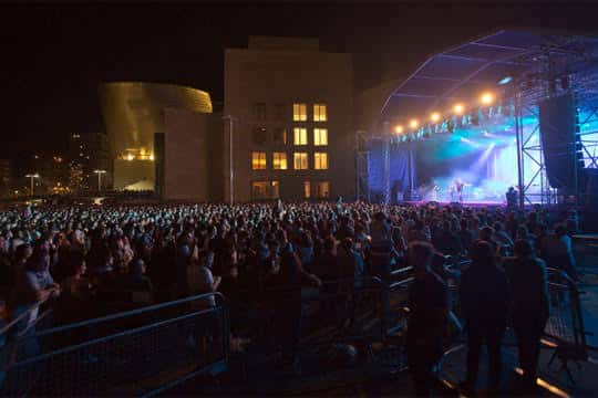 Concierto nocturno en el escenario de Abandoibarra con el Guggenheim Bilbao al fondo y multitud de asistentes