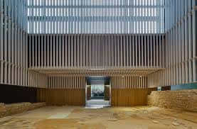 Espacio interior del museo con elementos arquitectónicos contemporáneos y restos arqueológicos