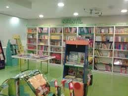 Sección infantil de la librería con estanterías coloridas y mobiliario adaptado para niños