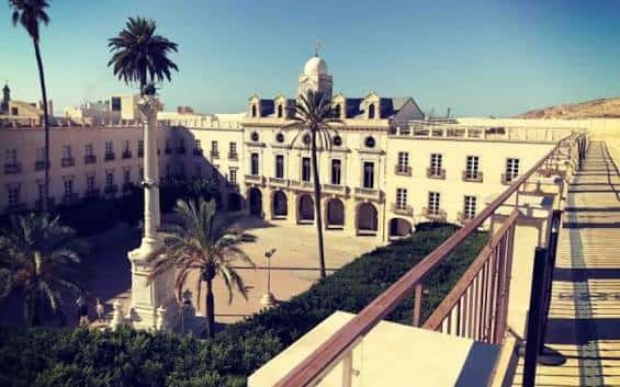 Vista panorámica del patio interior del edificio con columnas, palmeras y arquitectura clásica