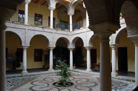 Vista del patio central con diseño de baldosas y arquería clásica